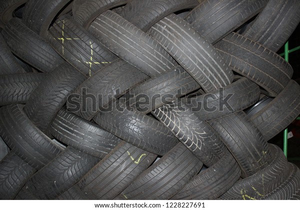 Car tires background. Tire wall. Rubber wheel.\
Tire factory.