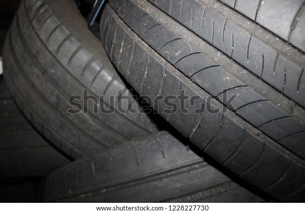 Car tires background. Tire wall. Rubber wheel.\
Tire factory.
