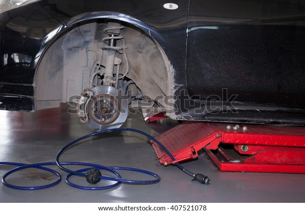 Car\
tires being removed and replaced in garage\
service