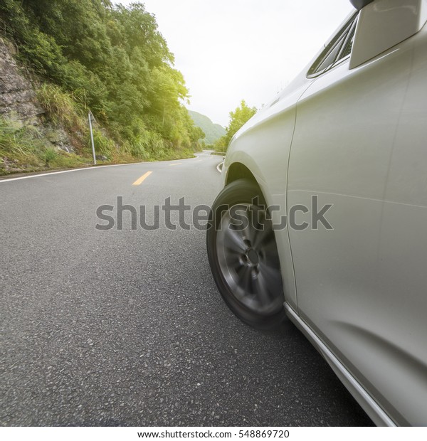 \
Car tires driving in the\
highway