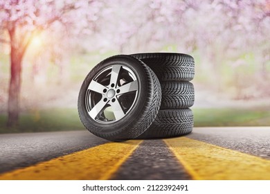 Car tires with a great profile in the car repair shop.  Set of summer or winter tyres in front of white fond. - Shutterstock ID 2122392491