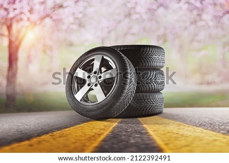 Car tires with a great profile in the car repair shop.  Set of summer or winter tyres in front of white fond.
