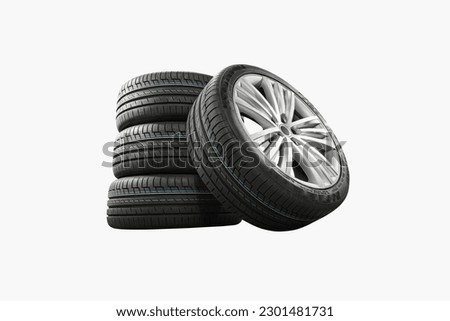Car tires with a great profile in the car repair shop. Set of summer or winter tyres in front of white fond. On white background.