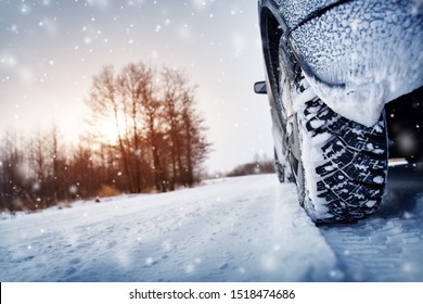 Car Tires On Winter Road Covered With Snow