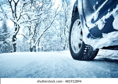 Car Tires On Winter Road Covered With Snow