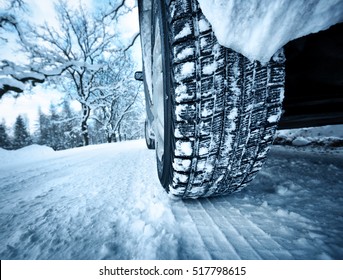 Car Tires On Winter Road Covered With Snow