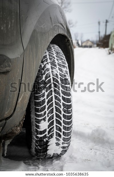 Car tires on winter road covered with snow.\
Vehicle on snowy way in the morning\
