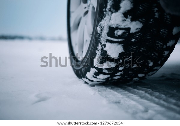 Car tires on\
winter road covered with\
snow