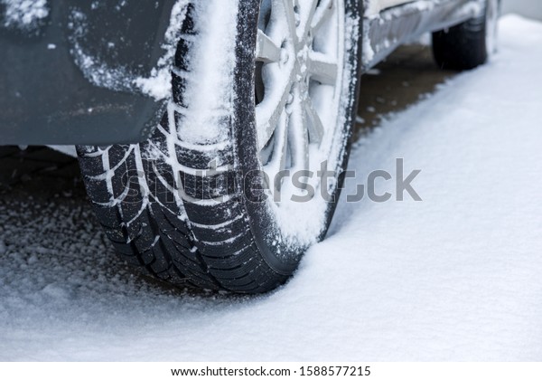 Car tires on\
winter road covered with\
snow.