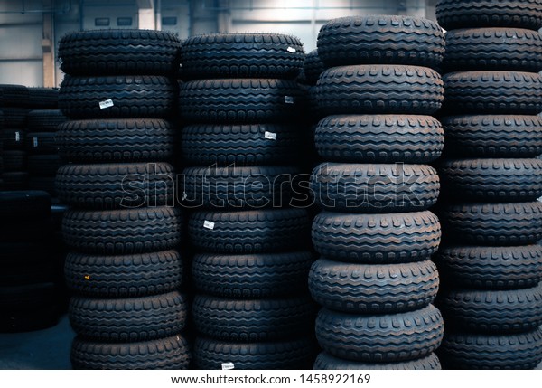 car tires\
pile. Black tires close-up with large tread. Isolated. Large rubber\
tires for trucks lying on the\
street.