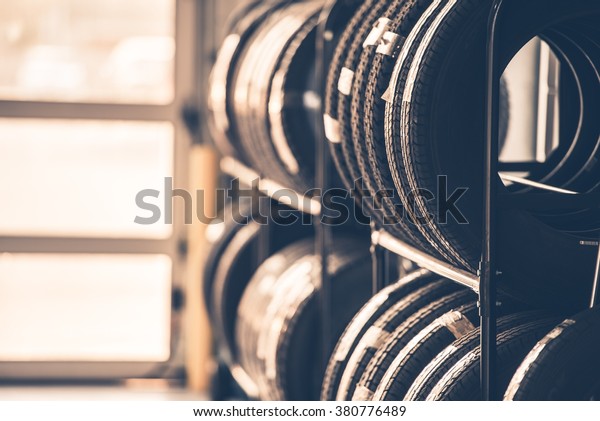 Car Tires Rack. Brand New Tires for Compact\
Vehicles on the Metal\
Display.