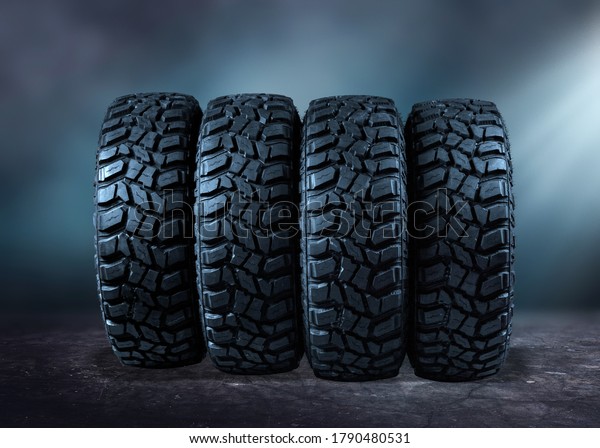 Car\
tires and smoke on road against black\
background