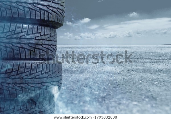 Car tires and smoke on road against grey\
nature background