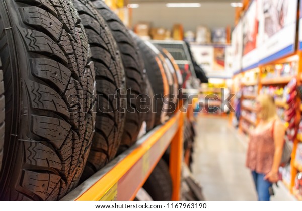 Car tires. Stack of winter tires. Car tires at\
warehouse in tire store.