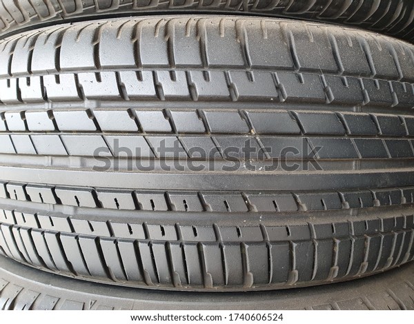 Car tires at warehouse in tire store. Tire\
textured for background.\
rubber