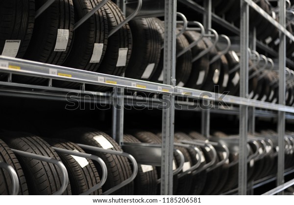 Car tires\
and wheels at warehouse in tire\
store.