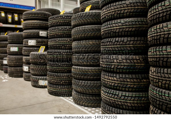 Car tires and
wheels at warehouse in tire
store