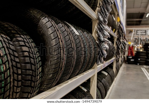 Car tires and\
wheels at warehouse in tire\
store