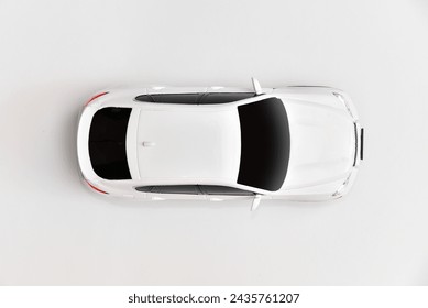 Car top view on the white background surface with copy space. Driving training concept. White car model, top view.
