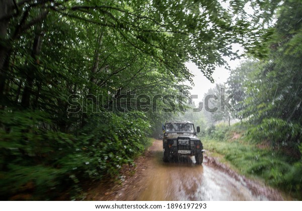 Car tour on mountains\
durring rainfall bad weather day. Carpathian Mountains, Ukraine -\
07.27.2016