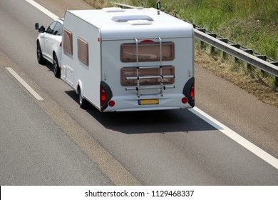 Car Towing Caravan On European Motorway