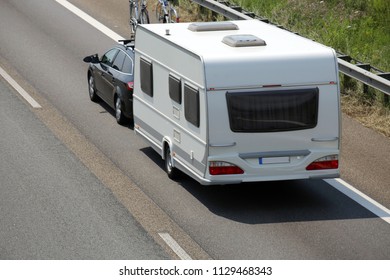 Car Towing Caravan On European Motorway