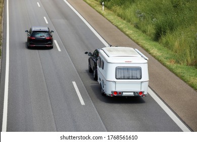 Car Towing Caravan On European Motorway