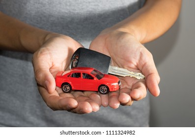 Car toy and key in woman hand. - Shutterstock ID 1111324982