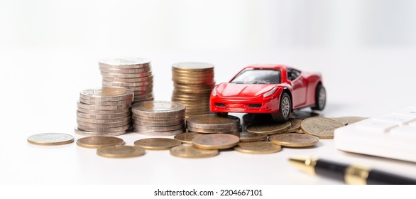 Car Toy Vehicle With Stack Coin Money On Background. Planning To Manage Transportation Finance Costs. Concept Of Car Insurance Business, Saving Buy - Sale With Tax And Loan For New Car.