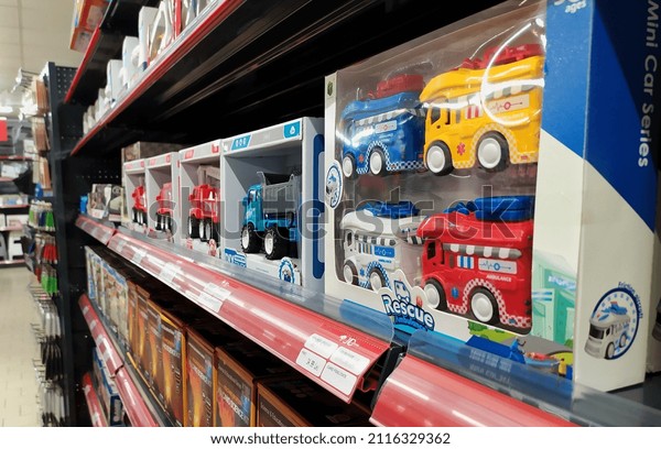 Car toys on the shelf in the store for sale. Toy
colored plastic cars in the children's store. Bucharest, Romania,
February 1, 2022