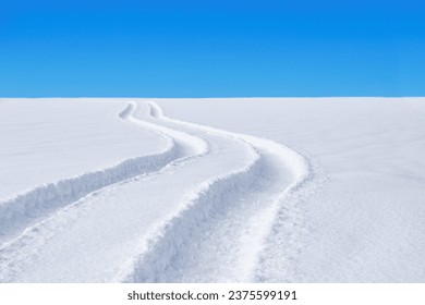 Car tracks in the deep fresh snow. winter landscape.