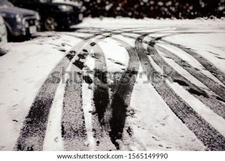 Car Tracks on the Snow Covered Road Background.