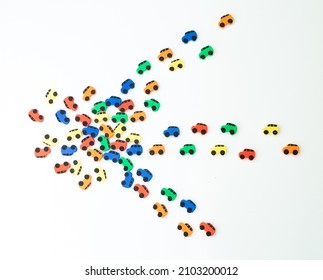 Car Traffic Jam From Small Toy Cars In The Form Of An Arrow Isolated On A White Background, Top View.