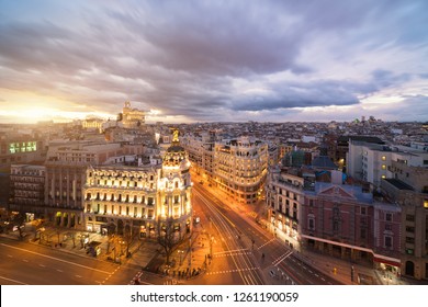 Car And Traffic Lights On Gran Via Street, Main Shopping Street In Madrid At Night. Spain, Europe. Landmark In Madrid, Landscape And Culture Travel, Or Historical Building And Sightseeing Concept