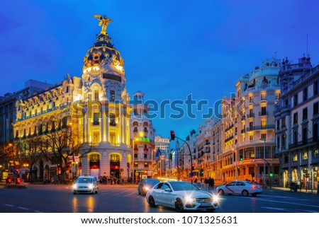 Car and traffic lights on Gran via street, main shopping street in Madrid at night. Spain, Europe.
