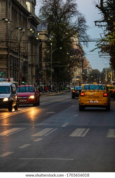 Car in\
traffic, modern city taxi service. Taxi cars parked at the taxi\
station. Car pollution, traffic jam in the morning and evening in\
the capital city of Bucharest, Romania,\
2020