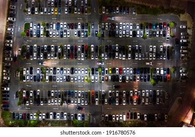 Car Traffic, Parking And Leaving Shopping Mall's Parking Lot At Night. Drone Aerial Top View. Transportation Travel, City Life, Or Shopping People Lifestyle Concept