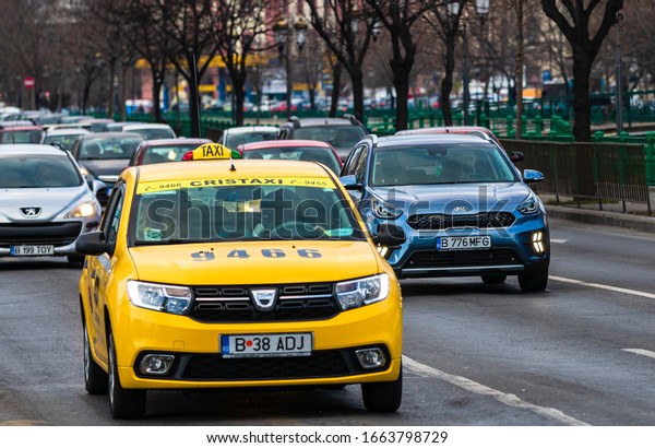 Car traffic at rush hour in\
downtown area of the city. Car pollution, traffic jam in the\
morning and evening in the capital city of Bucharest, Romania,\
2020