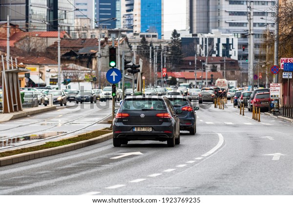 Car traffic at rush hour in\
downtown area of the city. Car pollution, traffic jam in the\
morning and evening in the capital city of Bucharest, Romania,\
2021