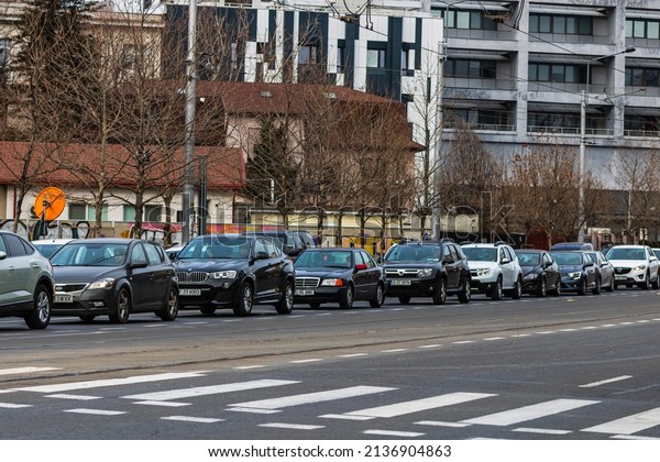 Car traffic at\
rush hour in downtown area of the city. Car pollution, traffic jam\
in Bucharest, Romania, 2022