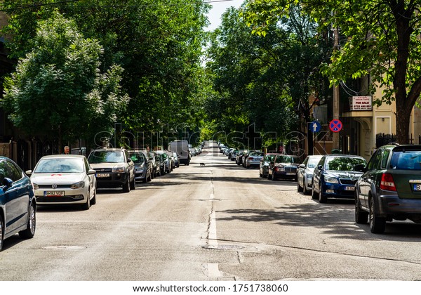 Car traffic at rush hour stopped at red\
light. Car pollution, traffic jam in the morning and evening in the\
capital city of Bucharest, Romania,\
2020