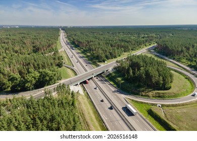 Car Traffic Transportation On Road At Junction Intersection In Countryside Forest, Aerial View