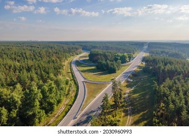 Car Traffic Transportation On Road At Junction Intersection In Countryside Forest, Aerial View