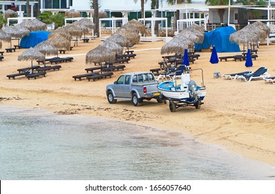 Car With A Trailer And A Motor Boat On The Seashore.