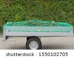 Car trailer with net for load securing