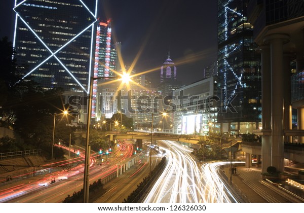 car trails with the building
with the landmark of bank of china in hong kong, financial
background