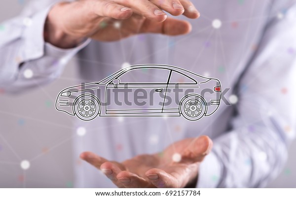 Car transport concept between hands of a man
in background