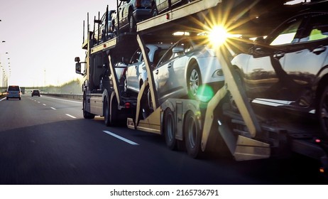 Car transporter trailer loaded and many cars highway  motion blur effect 