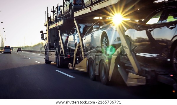 Car transporter trailer loaded with many cars on
a highway, motion blur
effect.