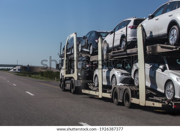car\
transporter transports cars on suburban\
highway
